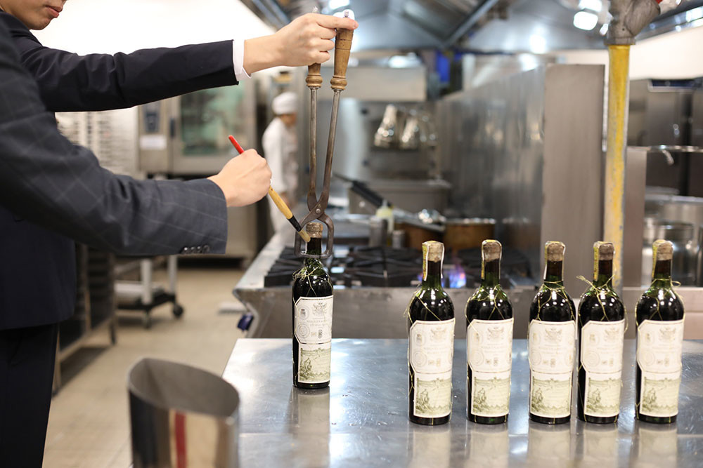 Sommeliers opening the Marqués de Riscal 1949 vintage with special equipment